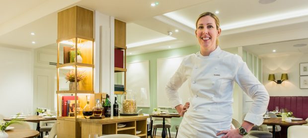 Female chef, Clare Smyth, poses for an environmental portrait in the beautifully lit dining room of her restaurant, Core in London