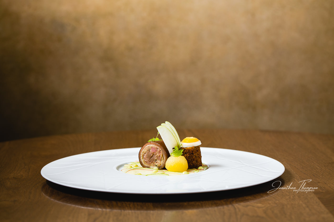 Promotional image with a fine dining pigs trotter dish showing The New Vintage Popup Background from Lastolite